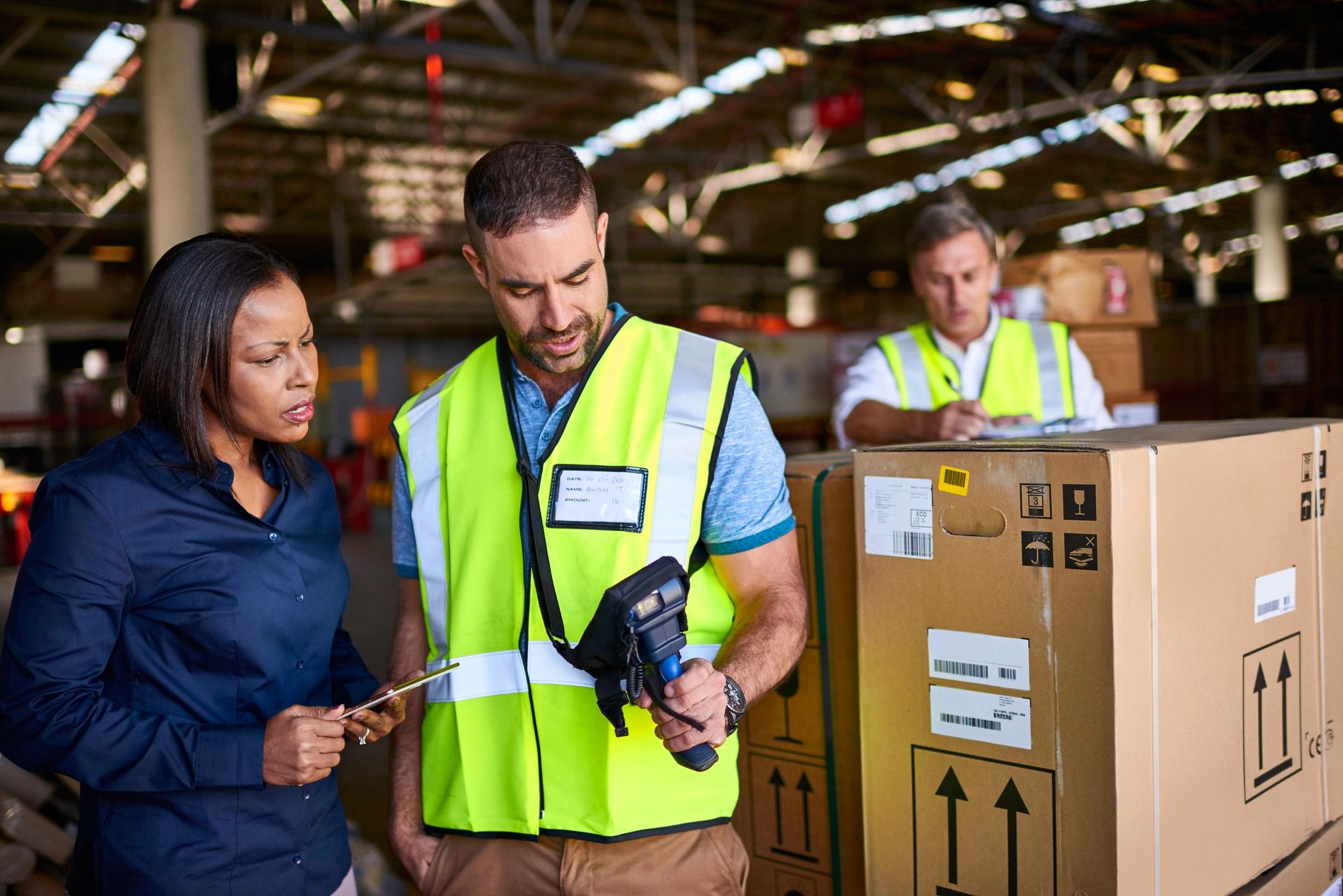 Warehouse workers discussing shipments